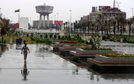 A man walks along a street as heavy rainfall continues in Baghdad on April 12, 2023. (Photo by AHMAD AL-RUBAYE / AFP) (Photo by AHMAD AL-RUBAYE/AFP via Getty Images)