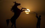 ERBIL, IRAQ - AUGUST 30: Silhouette of a man with his horse during sunset in Erbil, Iraq on August 30, 2023. (Photo by Ahsan Mohammed Ahmed Ahmed/Anadolu Agency via Getty Images)