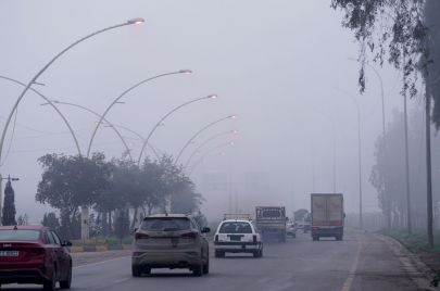 MOSUL, IRAQ - JANUARY 03: Vehicles are seen on their way during foggy weather in Mosul, Iraq on January 03, 2024. (Photo by Ismael Adnan Yaqoob/Anadolu via Getty Images)