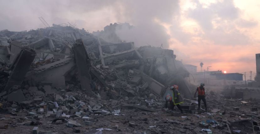 TOPSHOT - Palestinians inspect the damage outside Gaza City's Al-Watan Tower, destroyed by an Israeli airstrike early on October 8, 2023. Fighting between Israeli forces and the Palestinian militant group Hamas raged on October 8, with hundreds killed on both sides after a surprise attack on Israel prompted Prime Minister Benjamin Netanyahu to warn they were "embarking on a long and difficult war". (Photo by MOHAMMED ABED / AFP) (Photo by MOHAMMED ABED/AFP via Getty Images)